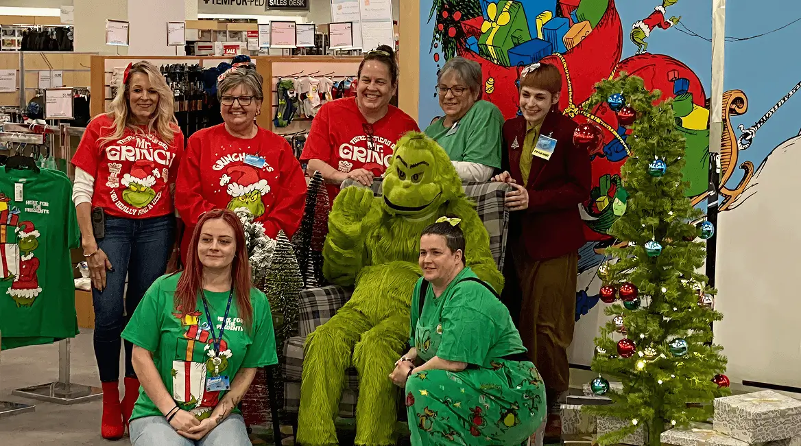 People in Christmas attire with Grinch